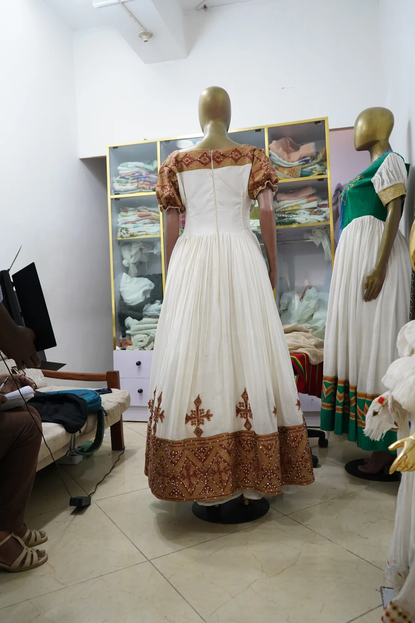 Hand woven habesha kemis decorated with golden woven embroidery, Cotton Wool fabric, Back — Shirib Shema